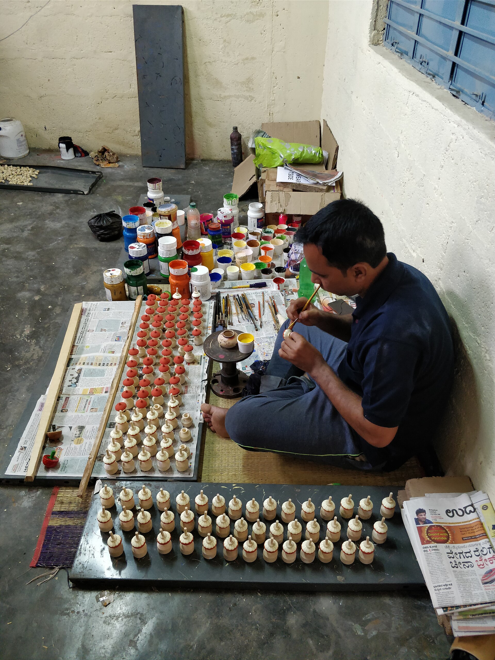 Channapatna artisan making lacquered wooden toys