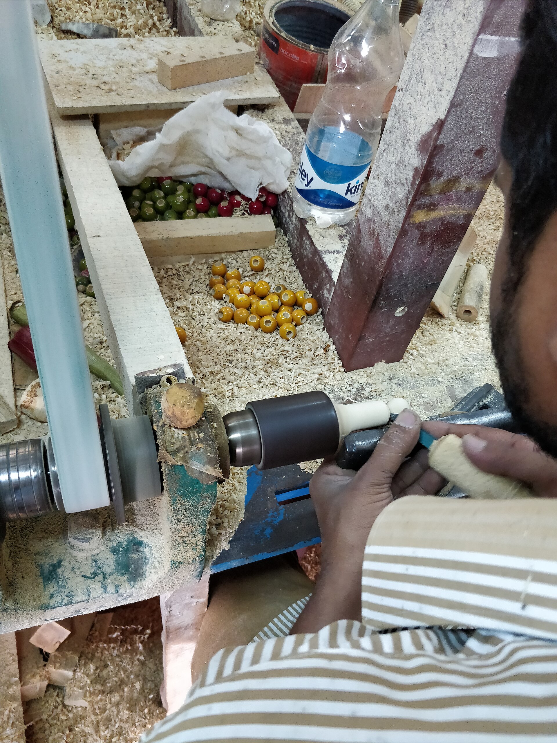 Channapatna artisan making lacquered wooden toys