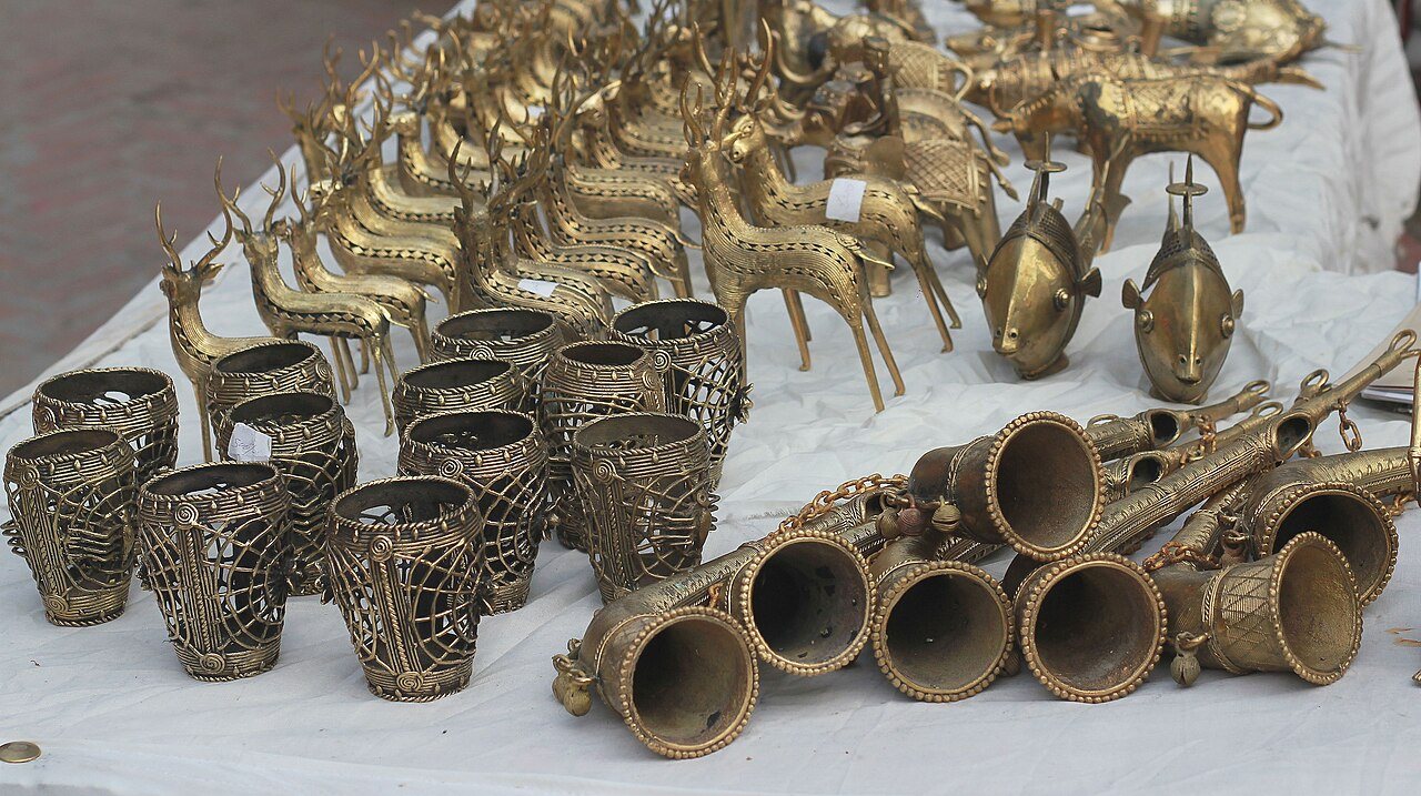 Dhokra brass pieces laid out on a white cloth