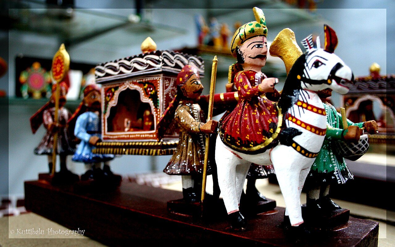 Painted Kondapalli wooden toys: a white horse, a palanquin carried by bearers and costumed figures